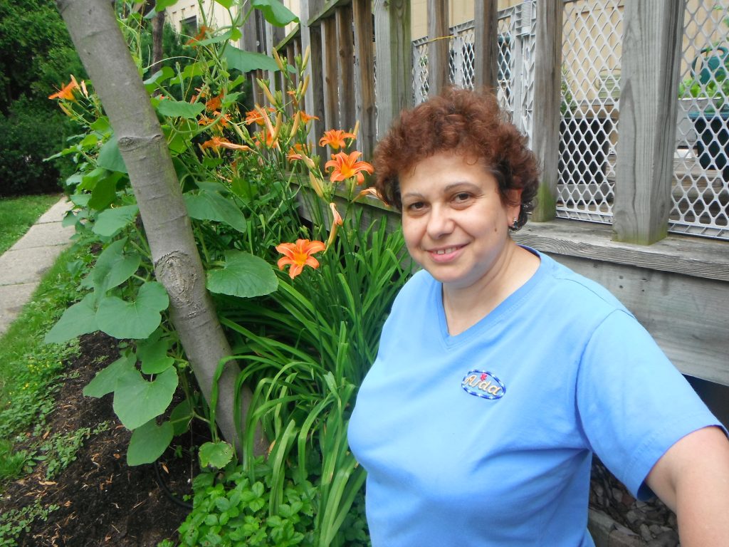 woman standing by flowers